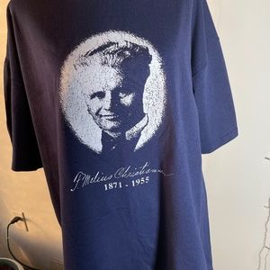 Navy blue short-sleeve t-shirt w/F. Melius Christiansen's image on the front.